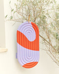 Hercule Studio Galé Axel red orange pad in lifestyle, 3-in-1 printed mini mat for Pilates class and Reformer, colorful design made in France