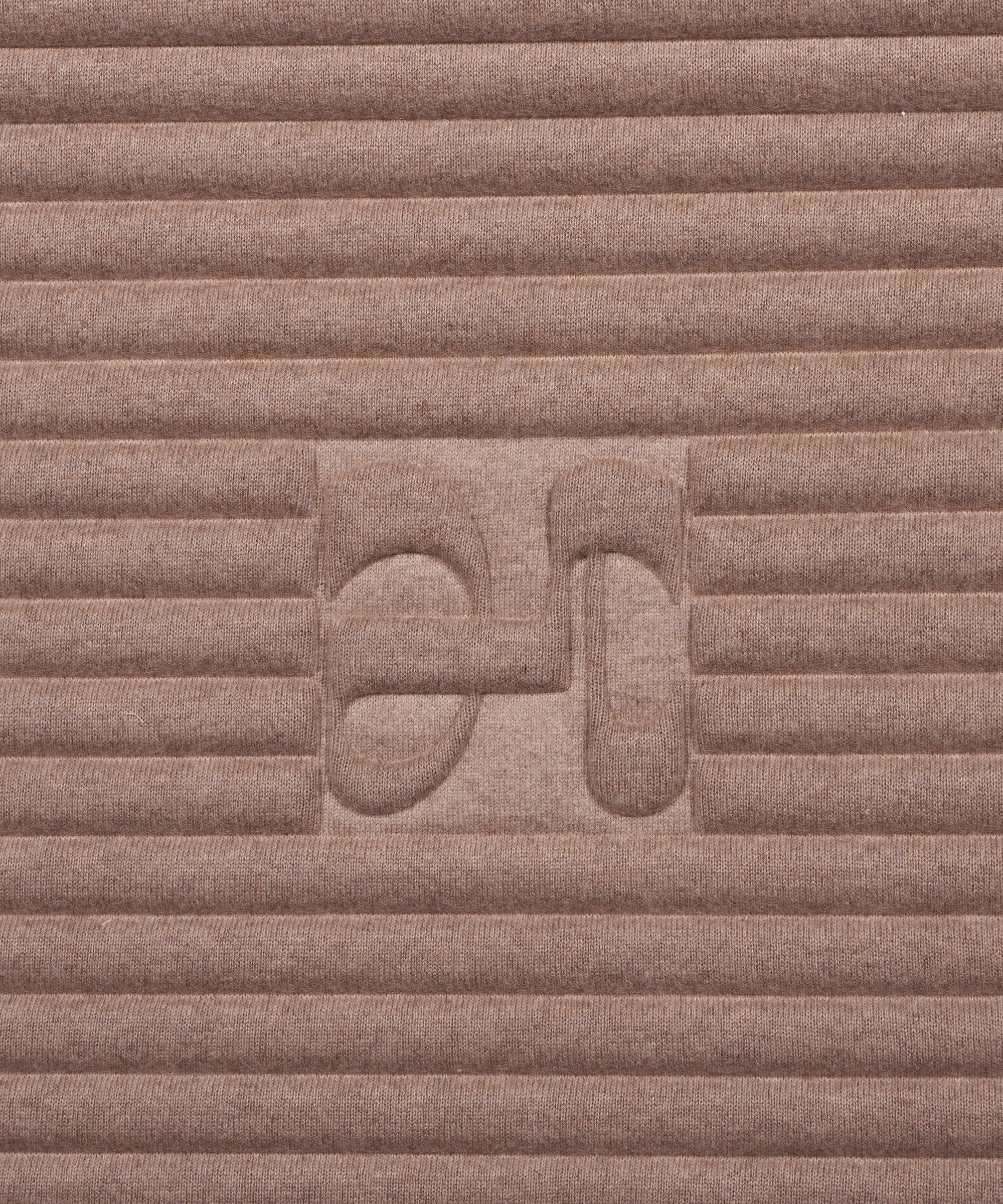 Close-up on the beige cashmere texture and embossed H logo of the Hercule Studio x From Future Sandy Brown sport mat