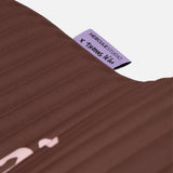 Close-up on the custom Hercule Studio x Thomas Lélu label, premium textile finish of the sport mat