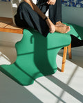 Hercule Studio yoga mat, “Mar” model in golf green, close-up photo on a bench