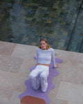 Hercule Studio Mar Lavender Yoga Mat in a lifestyle setting, featuring a soft purple hue perfect for yoga and meditation sessions, made of PVC-free natural rubber and paired with a terracotta-colored mini exercise mat